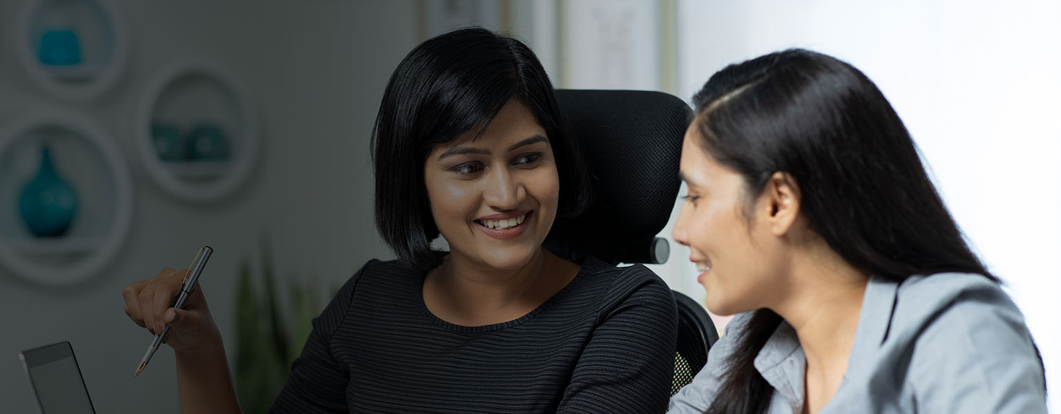 Business women discussing something together.